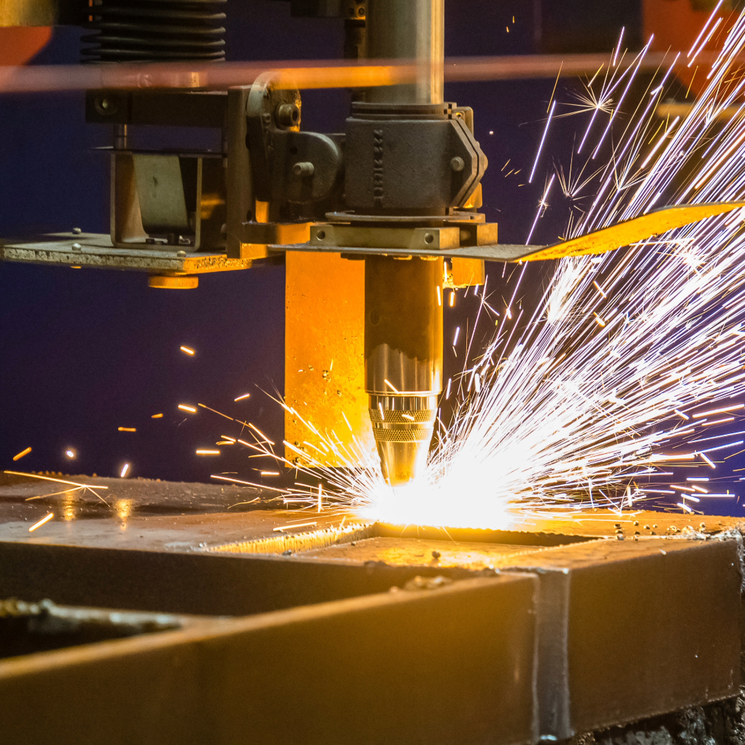 a machine cutting into metal with fire sparks coming out 