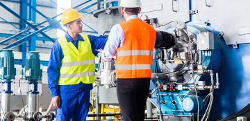 Two men looking at machinery